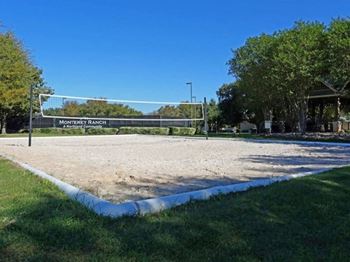 a volleyball court in a park on a sunny day